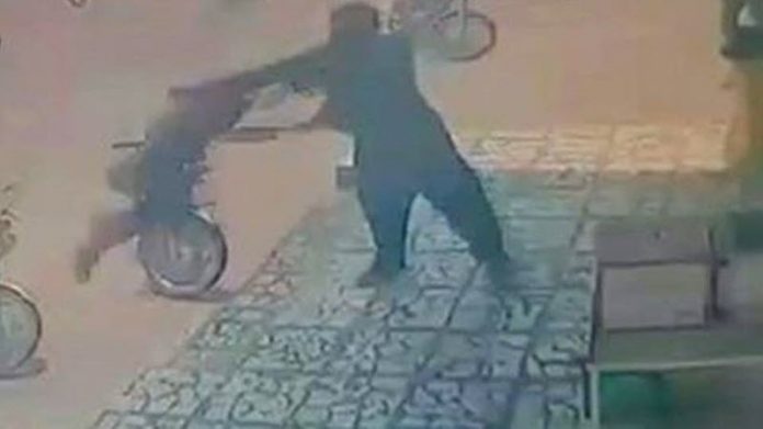 Iranian_Regimes_Security_Agent_Beats_an_Afghan_Child